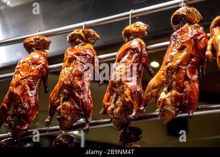 Delicious crispy roast ducks hanging in the display window of Lotus Garden restaurant in Chinatown, London, UK Stock Photo