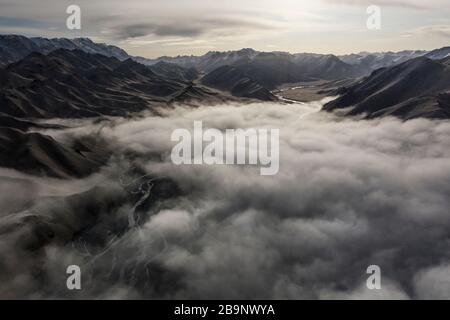 Aerial landscape short after autumn sunrise over the Kurmduk Valley in the vicinity of the Ak-Sai Valley and Kol Suu lake, showing the Kurumduk River Stock Photo