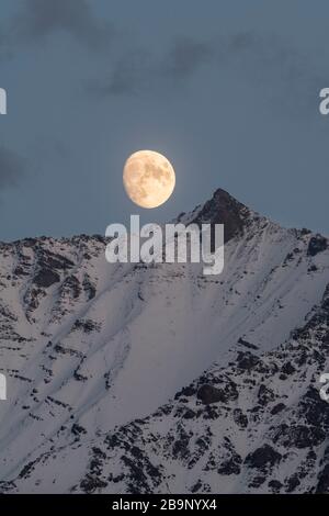 Last night before the supermoon rising over the Tian Shan mountains in southern Kyrgyzstan Stock Photo