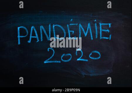 The word is in french 'pandemic'. The text on the chalk Board. Blue chalk Stock Photo