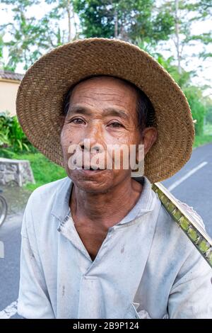 Middle age Indonesian farmer with straw hat. Indonesia, July 2nd 2016. Stock Photo