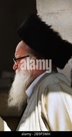 A Hasidic Jewish man wearing a Shtreimel ( traditional Fur hat ) in Mea Shearim neighborhood in Jerusalem. Stock Photo