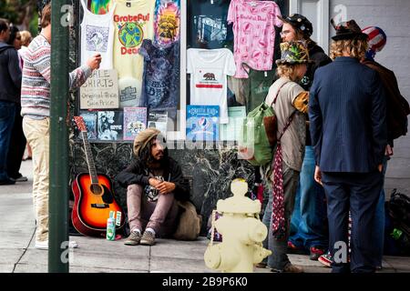 Preppy tourist taking a picture of locals in costumes in Haight-Ashbury District, San Francisco, California, United States, North America, color Stock Photo