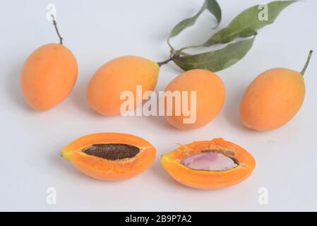 Sweet Marian plum or Plango  in a wicker basket. Yellow-orange color tropical fruits. Thai fruits Stock Photo
