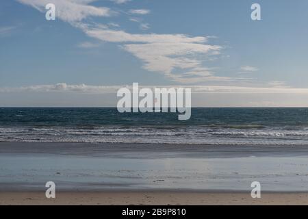 Desolate Zuma Beach vista during California stay-at-home order with a single kite surfer in the background, Malibu Stock Photo