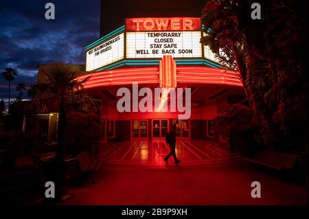 Sacramento, CA, USA. 24th Mar, 2020. Kevin Slattery walks by the Tower movie theater closed to the public as Californians shelter at home during the coronavirus outbreak on Tuesday, March 24, 2020 in Sacramento. Credit: Paul Kitagaki Jr./ZUMA Wire/Alamy Live News Stock Photo