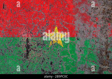 National flag of Burkino Faso  on old peeling wall background.The concept of national pride and symbol of the country. Stock Photo