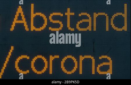 25 March 2020, Saxony, Dresden: The words distance and corona can be seen on a digital display board in Dresden's university quarter. To contain the corona virus, Saxony now bans all accumulations of three or more people in public. Photo: Robert Michael/dpa-Zentralbild/dpa Stock Photo