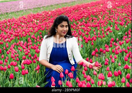 Young woman is enjoying flower fields in Holland Stock Photo