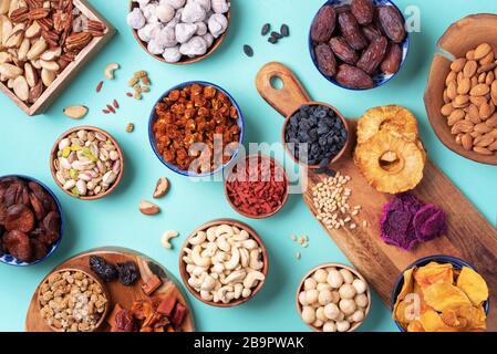 Assortment of nuts and dried fruits - brazil nuts, cashew, pecan, almonds, macadamia, pine nuts, hazelnuts, pineapple, raisins, dates, dried apricots, Stock Photo