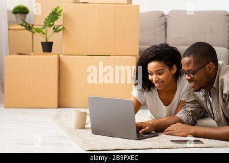 Millennial couple searching design project on laptop Stock Photo