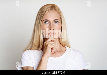 Close up of pensive middle aged woman Stock Photo