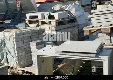 Concrete plates or cobble stones of large dimension piled on wooden pallets in the storage of building or construction material Stock Photo