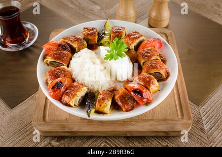 Turkish Beyti Kebap garnished with vegetables Stock Photo
