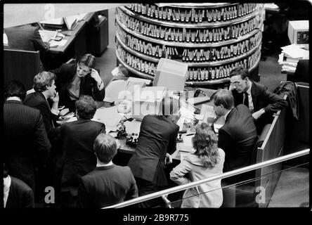 City of London. Lloyd’s of London Insurance trading floor photographed with permission in 1988. Lloyd's of London, generally known simply as Lloyd's, is an insurance and reinsurance market located in London, United Kingdom. Unlike most of its competitors in the industry, it is not an insurance company; rather, Lloyd's is a corporate body governed by the Lloyd's Act 1871 and subsequent Acts of Parliament. It operates as a partially-mutualised marketplace within which multiple financial backers, grouped in syndicates, come together to pool and spread risk. These underwriters, or 'members', are a Stock Photo