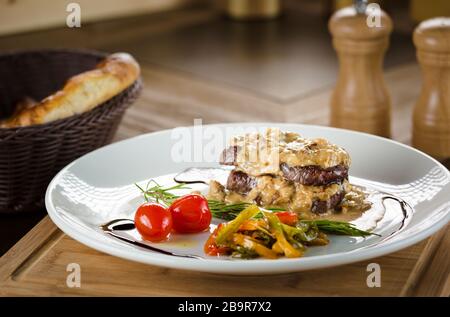 Roasted Turkish meat balls with baked potatoes and green chilly pepper on the wooden background. Roasted Turkish cutlets. Stock Photo