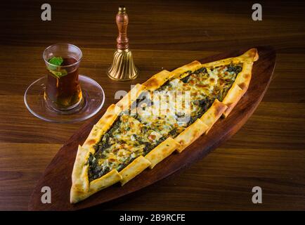 Traditional autyhentic turkish lunch or dinner: kebab with rice and vegetables, spinach and egg pide, pita flat bread and puff hot lavash or lavas Stock Photo