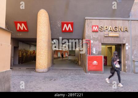 ROME, ITALY - 12 March 2020:  A woman wearing a face mask exits the Spagna underground railway station in Rome, Italy. Today, the Italian government d Stock Photo