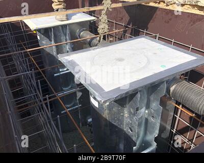 Pouring concrete to road bollard formwork foundation. Stock Photo