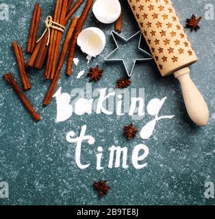Baking time. Flour sprinkled on the blue table with text baking time. Baking ingredients. Stock Photo