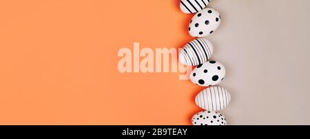 Easter eggs dotted on multicolored background. Festive concept. Flat lay style Stock Photo