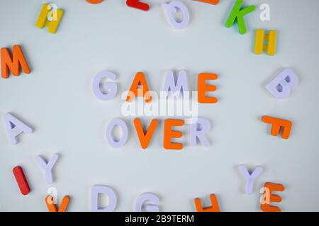 Game over word written with different colored letter blocks arranged on a light background Stock Photo