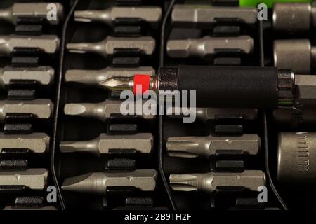 In the foreground a bit holder. Screwdriver bit set. Stock Photo