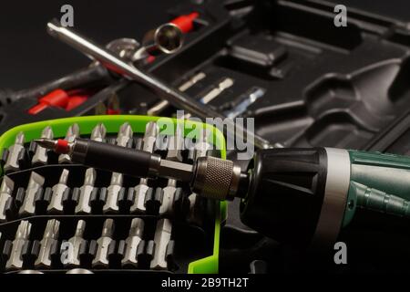 Cordless with bit holder in the foreground. Screwdriver bit set. Stock Photo