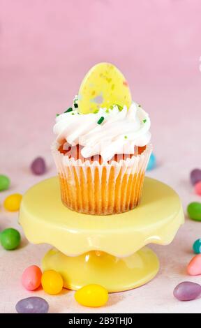 Cupcake on a cake stand on pink background Stock Photo