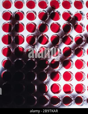silhouette of gloved hand over medical samples Stock Photo