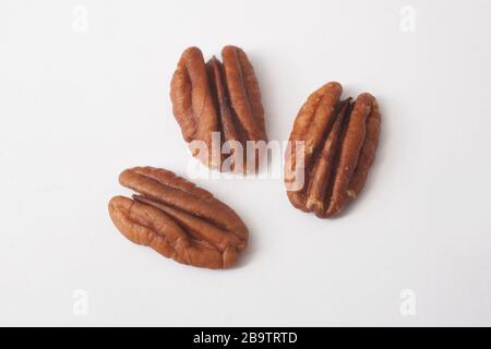 3 pecan nuts against a white background Stock Photo