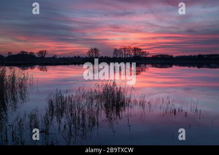 Wonderful colorful clouds over the lake after sunset Stock Photo