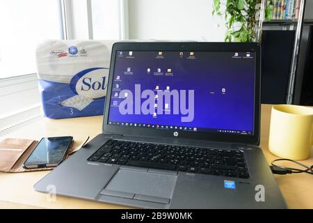 : laptop notebook at home office, coffee mug, toilet paper, in , , Austria Stock Photo