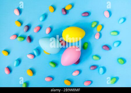 Easter decoration eggs and candy on blue background. Easter background Stock Photo