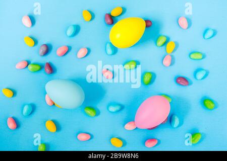 Easter decoration eggs and candy on blue background. Easter background Stock Photo