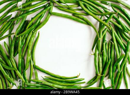 Green beans on white background, frame, copy sapce, top view. Stock Photo