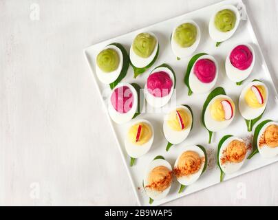 A plate of deviled eggs on dark grey stone background, top view, copy space Stock Photo
