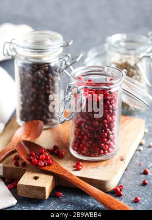 Pink, White and black peppers in a glass jars Stock Photo