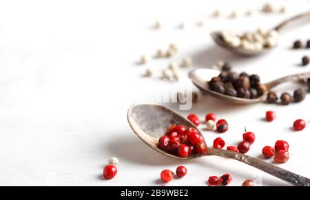 Pink peppers in spoon, copy space Stock Photo
