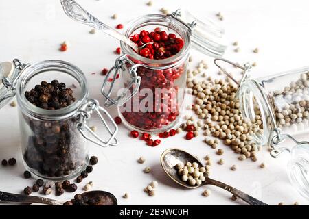 Pink, white and black peppers in a glass jars Stock Photo