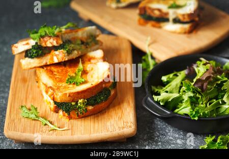 Broccoli and cheddar cheese sandwiches on wooden cutting boards. Stock Photo