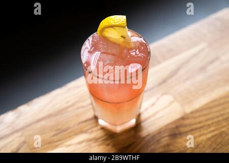 Summer cocktail on sunlit table top. Stock Photo