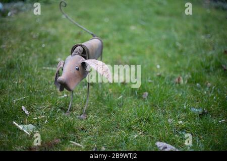 Selective focus shot of handmade metal mouse statue on a grassy field Stock Photo