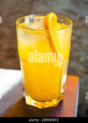 Screwdriver cocktail - vodka and orange in sunlight. Stock Photo