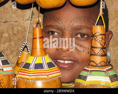 Gourds decorated with beads. The dry gourd is used for storing liquids. Photographed in a Datooga village, Tanzania Stock Photo