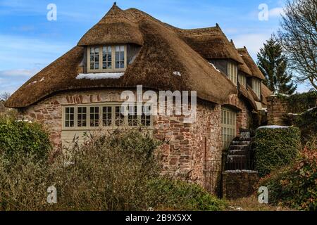 Cockington Mill Cottage with water wheel, in Cockington country park, Torquay, Devon, UK. March 2018. Stock Photo