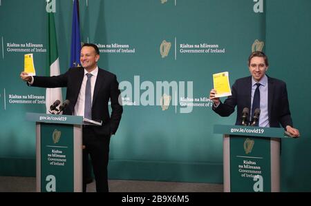 Taoiseach Leo Varadkar (left) and Minister for Health Simon Harris during the launch of a public information booklet on coronavirus at Government Buildings in Dublin. Stock Photo