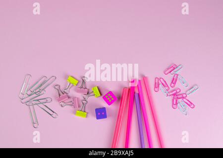 Multi-colored red and pinc pencils rulers, pens, pencils and scissors and stationery stand on a pink background Stock Photo