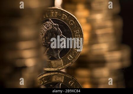 British one pound coins stand stacked in this arranged photograph,  Wednesday, Mar. 25, 2020. Photographer: Jason Alden/Bloomberg Stock Photo