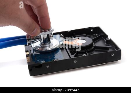 Stethoscope and hard disk drive isolated on a white background. Stock Photo